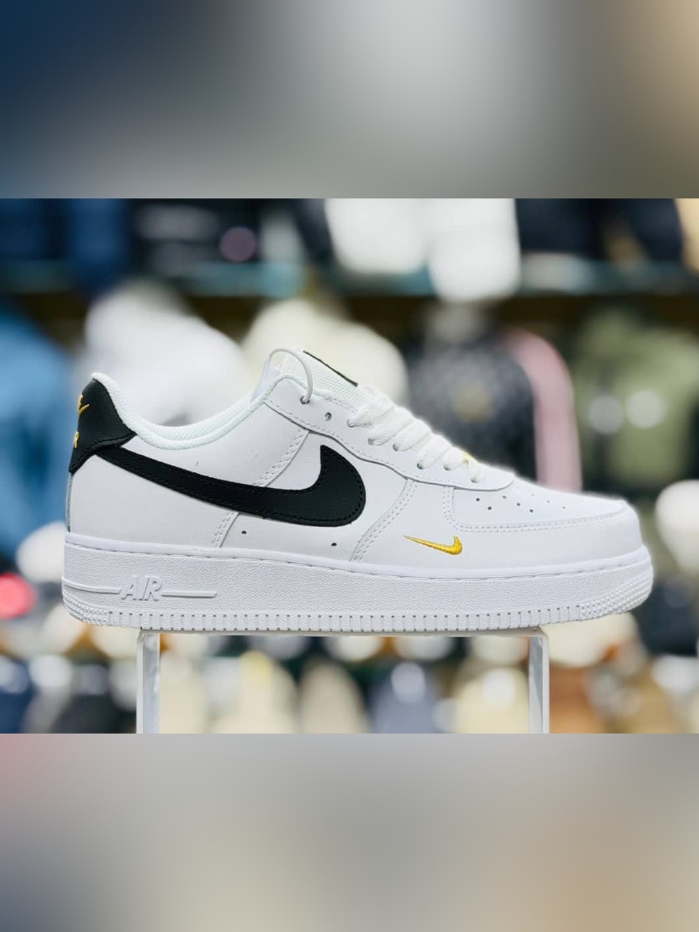 Nike White Low-Top Sneakers with Black and Gold Swooshes
